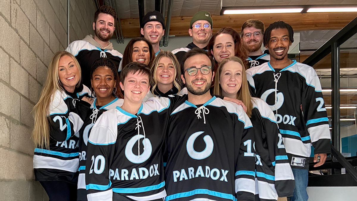 Paradox team members at a hockey game wearing Paradox hockey jerseys