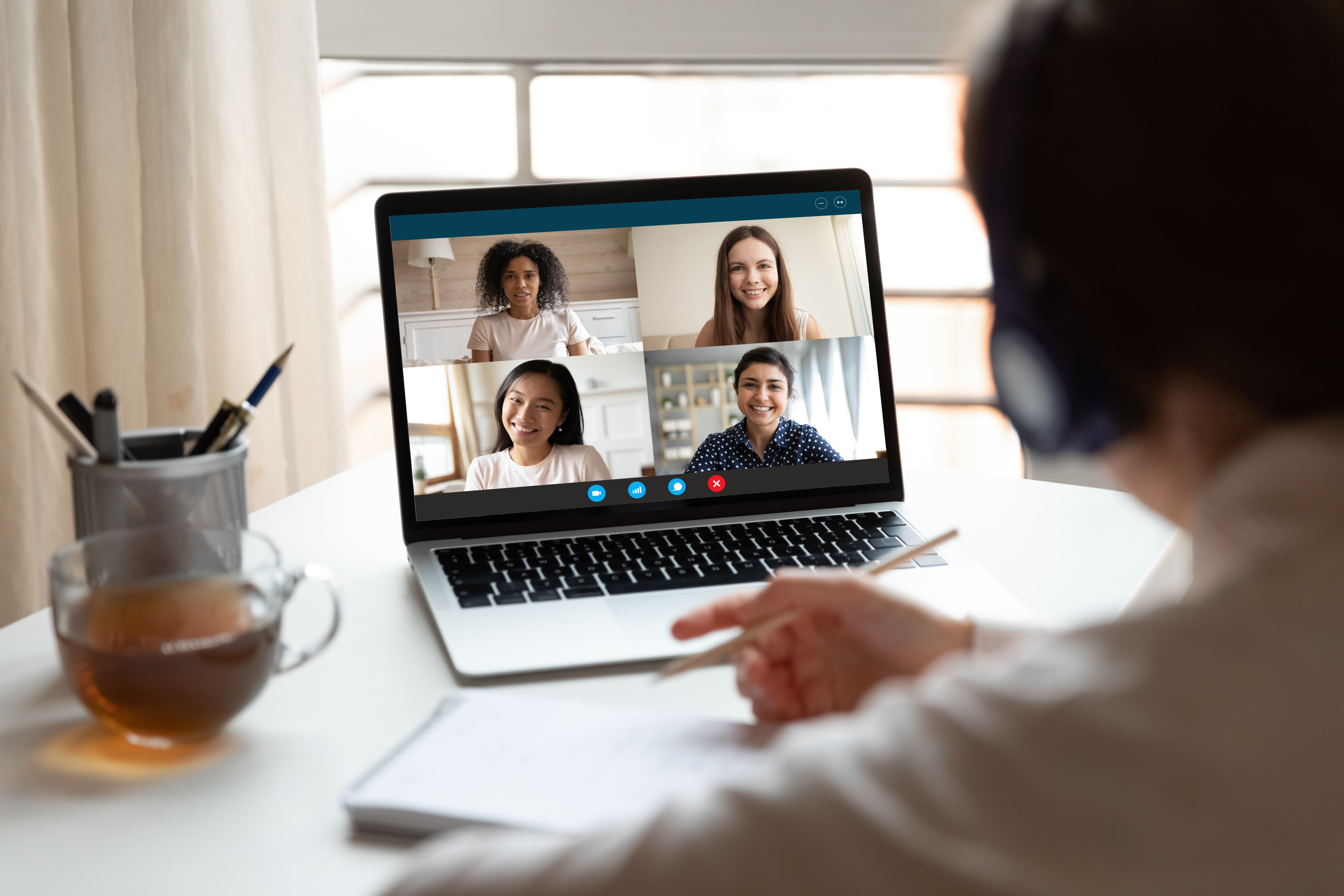 A meeting taking place virtually on a laptop