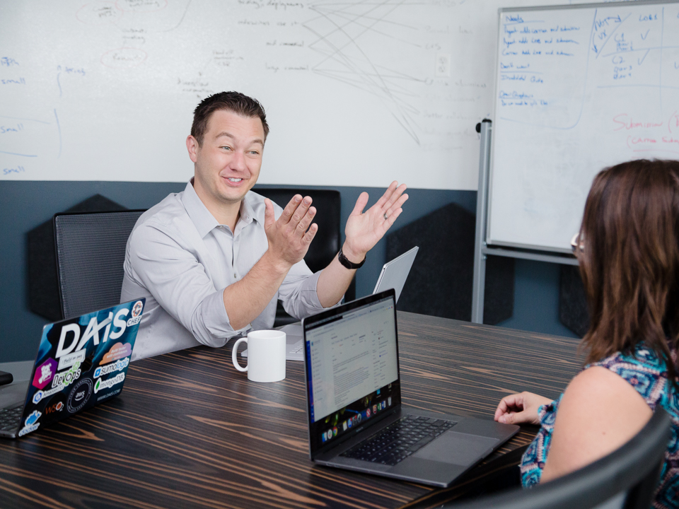 Jason Kolb laughs with coworkers