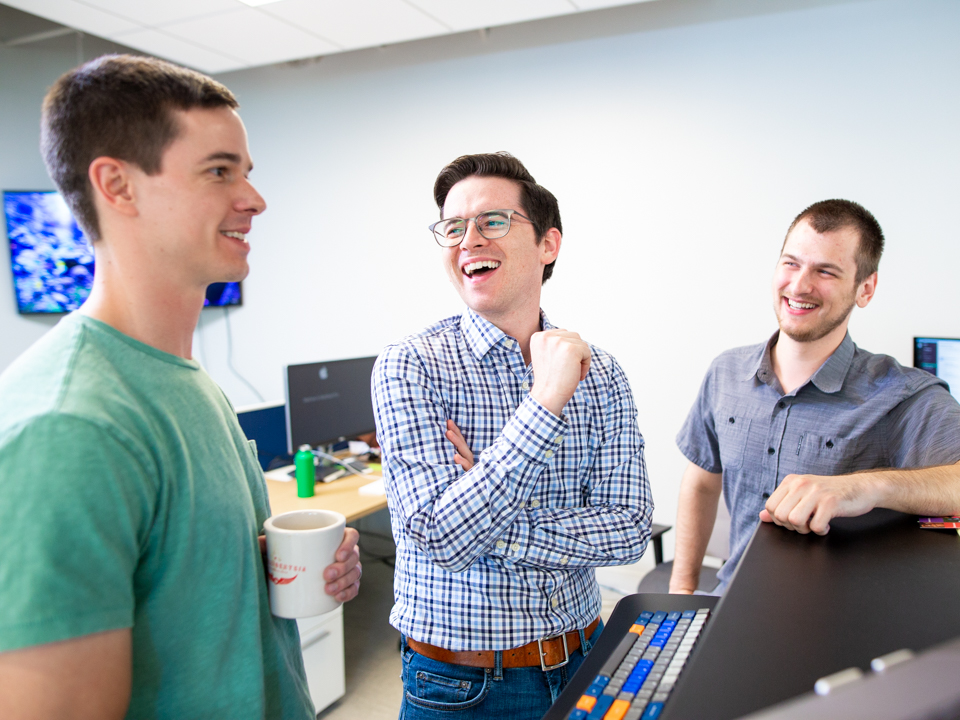 John Turner laughs with coworkers