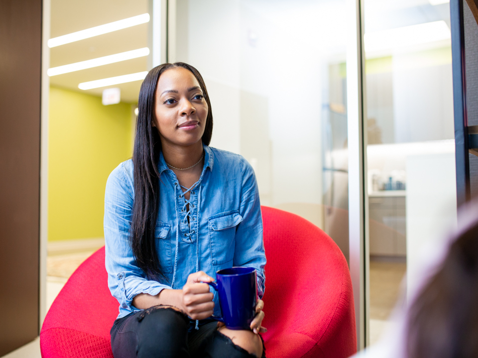 Tashma Scott listens to a coworker