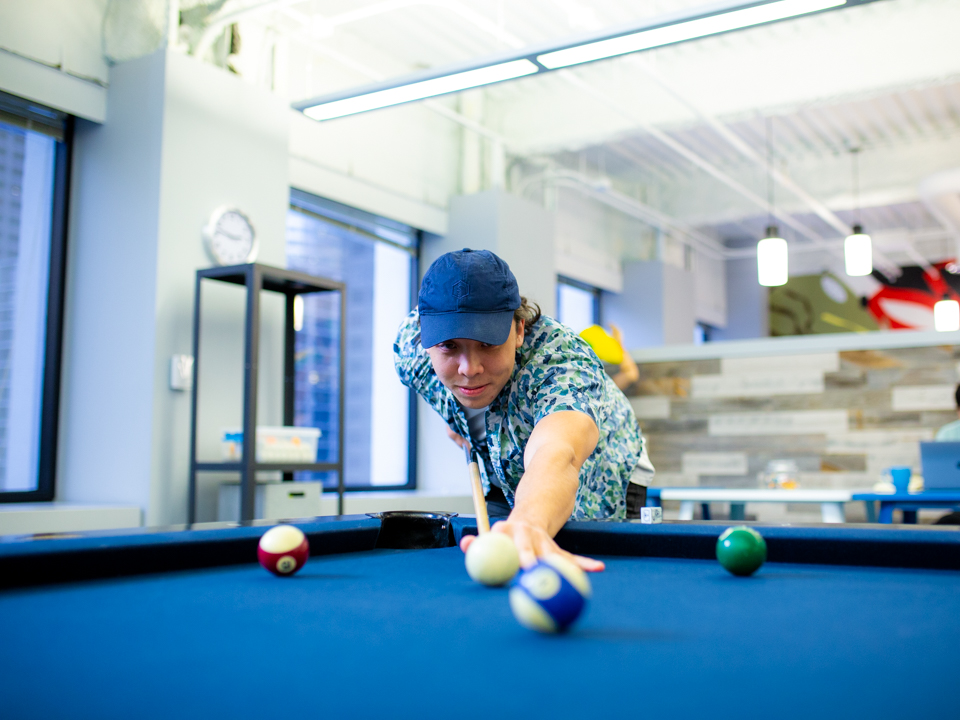 Employees play pool at Buildout
