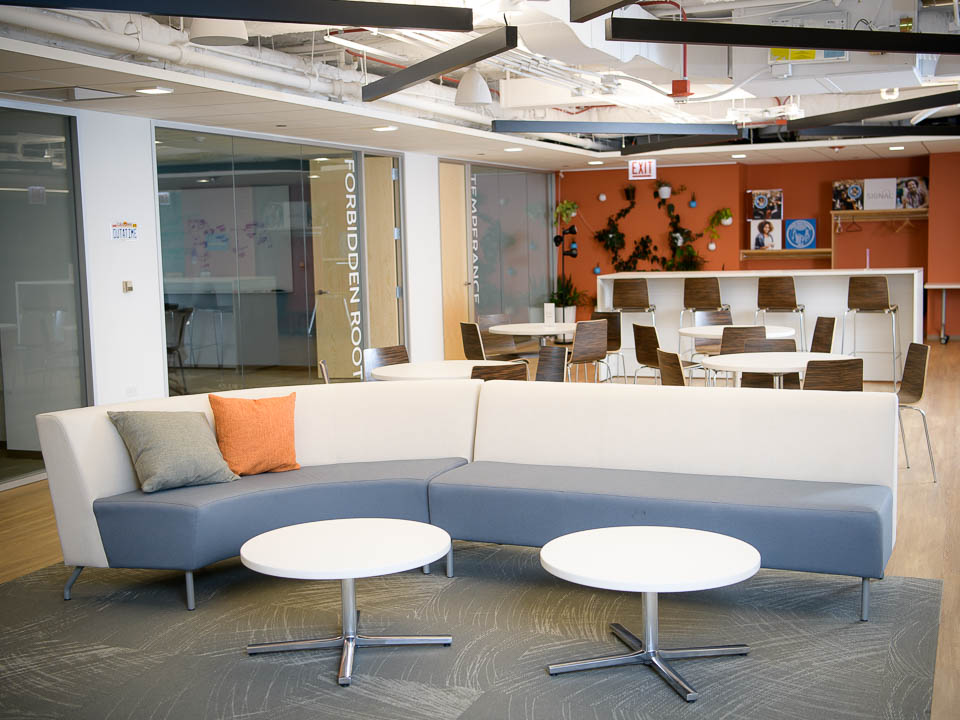 Large, open space in Signal's office with plants, tables, and sofas