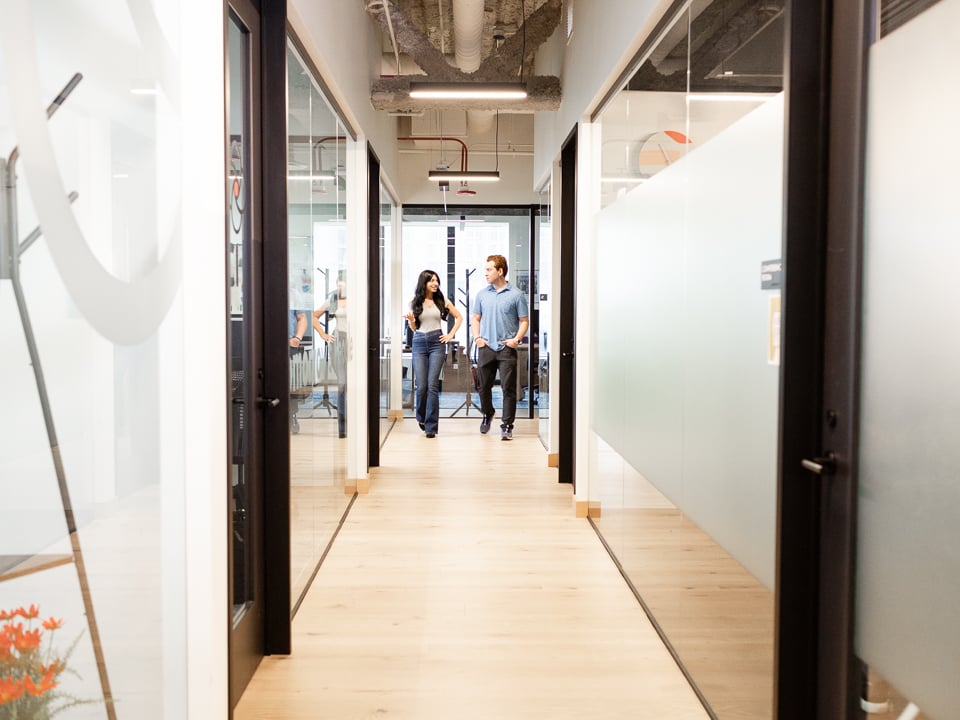 Two Logiwa team members walking down a hall in the office.