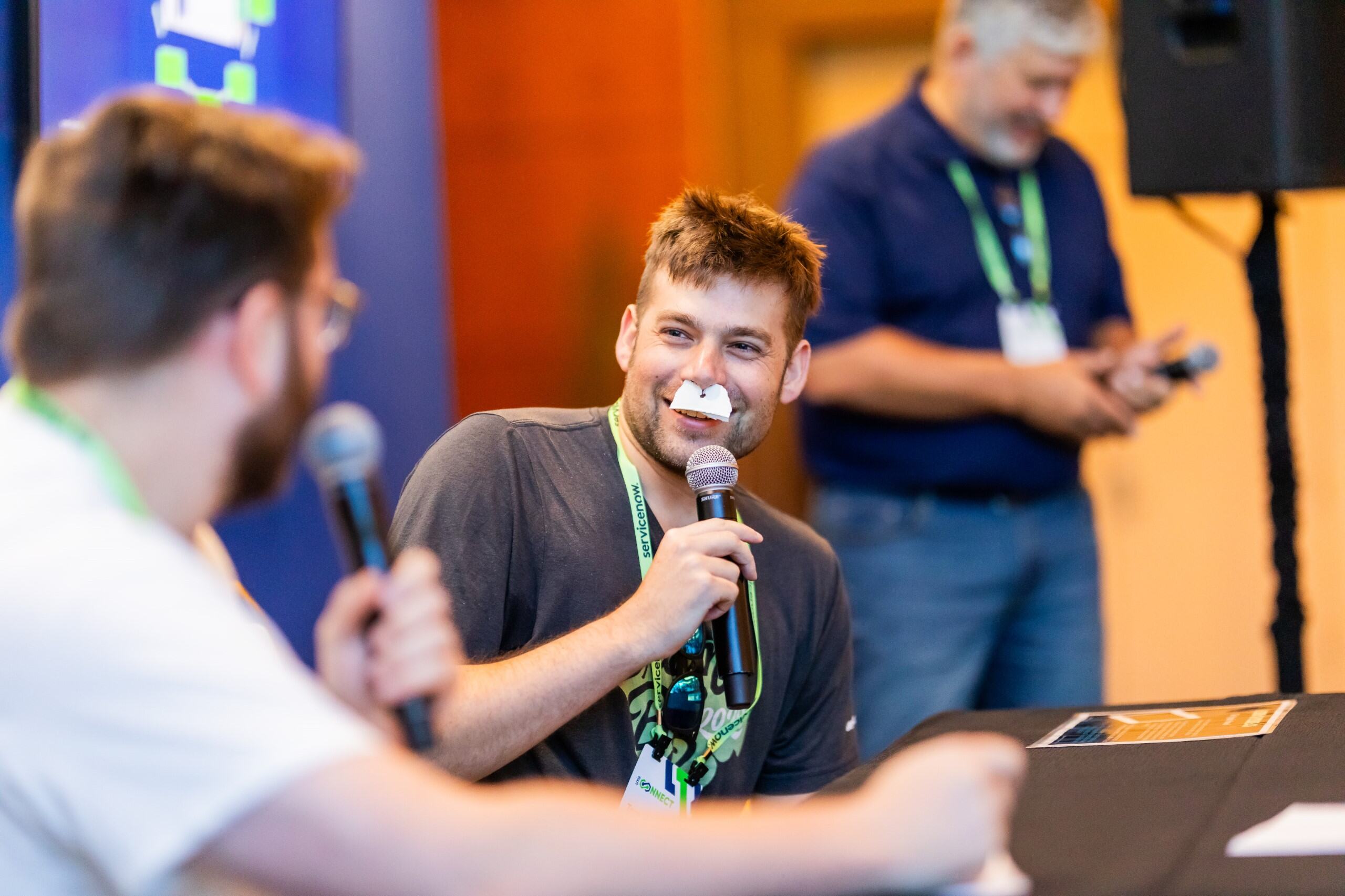 ServiceNow employees participating in games and exploring event booths.