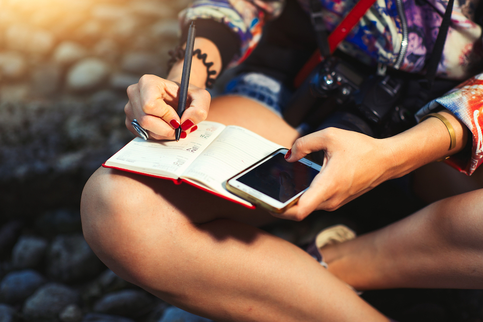 female journalist writing in notebook 