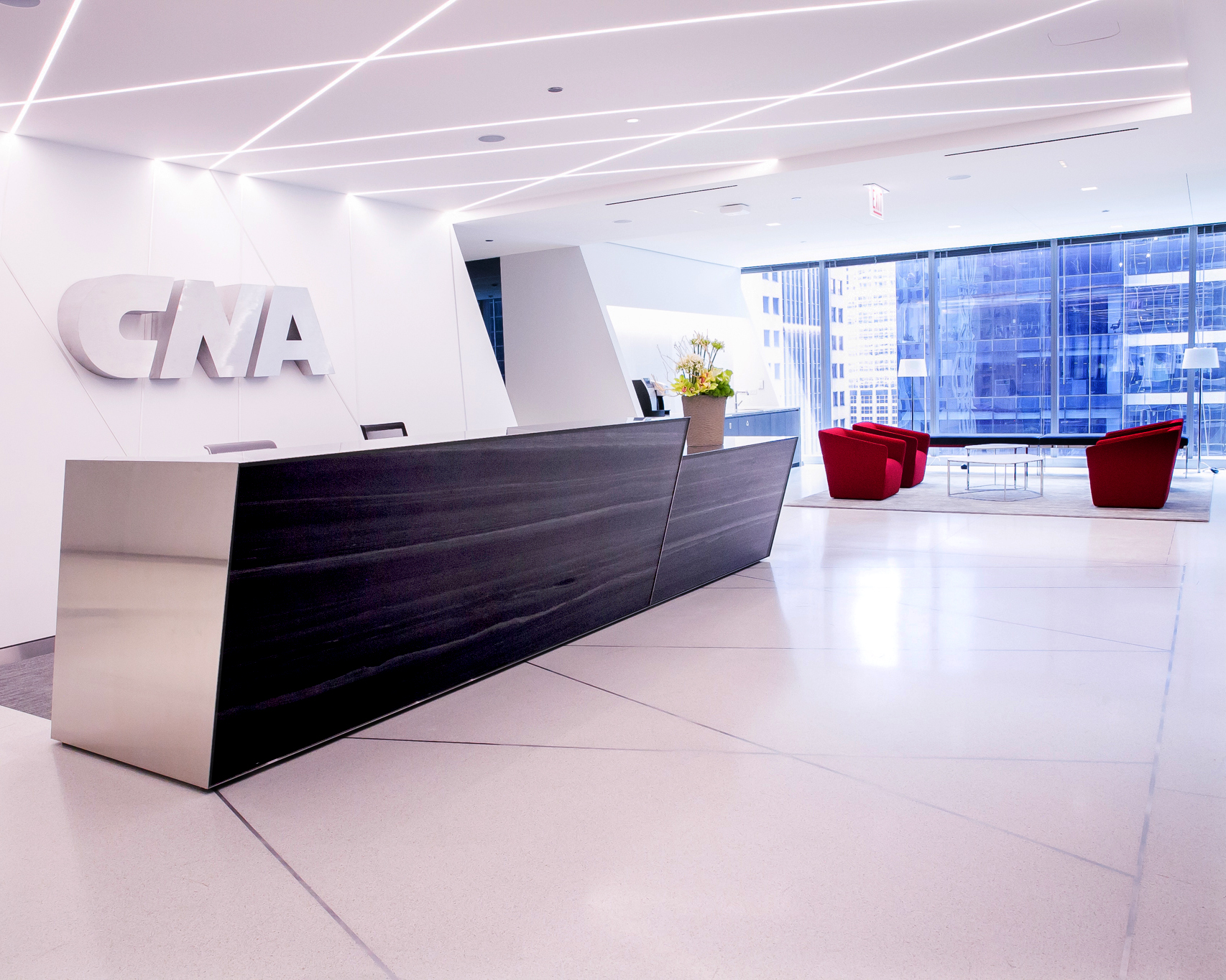 front lobby and reception desk of CNA HQ with white logo on the wall