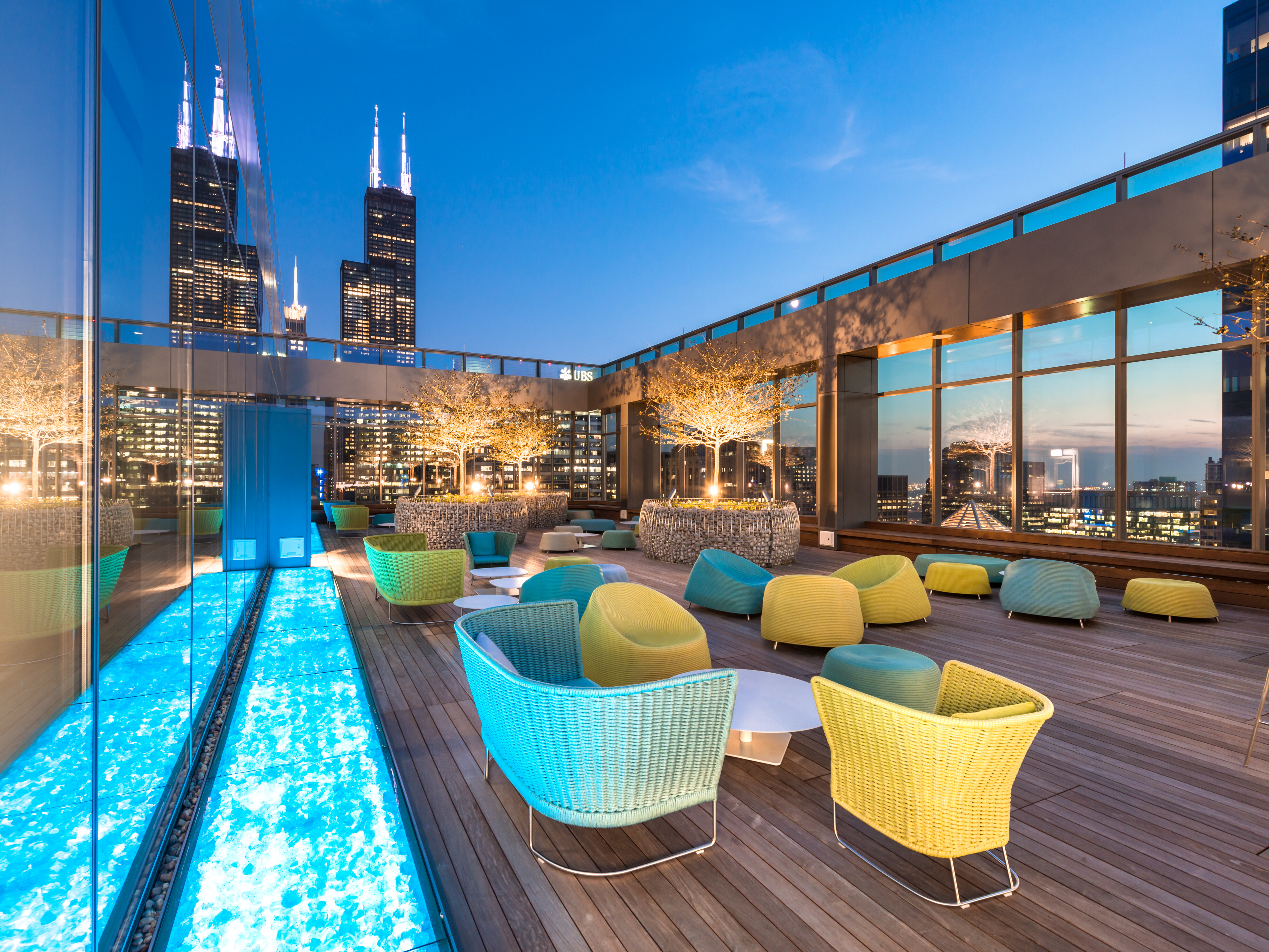 CNA office patio space with downtown Chicago skyline view at dusk