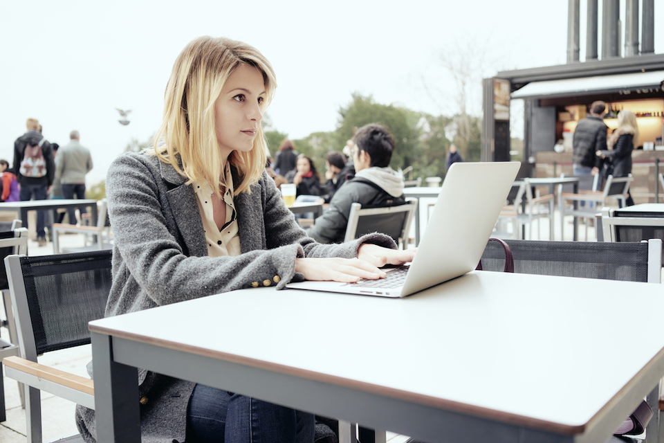 woman works at laptop on roof of co-working space