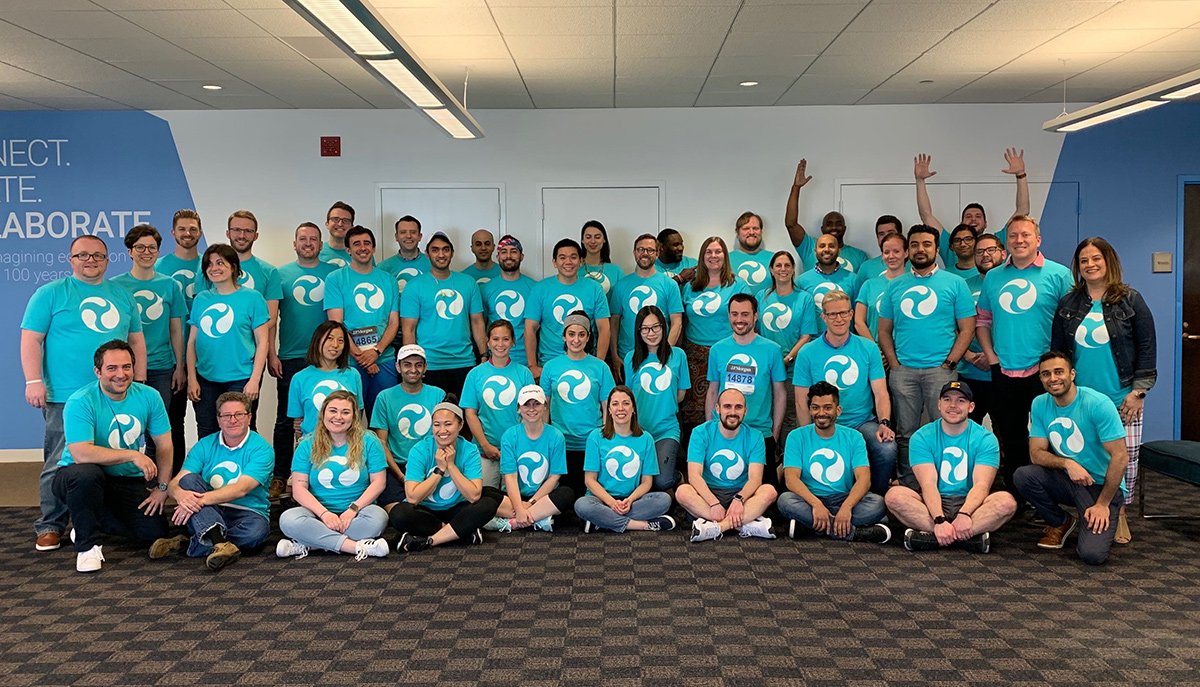 Everspring group photo with team members wearing matching teal t-shirts