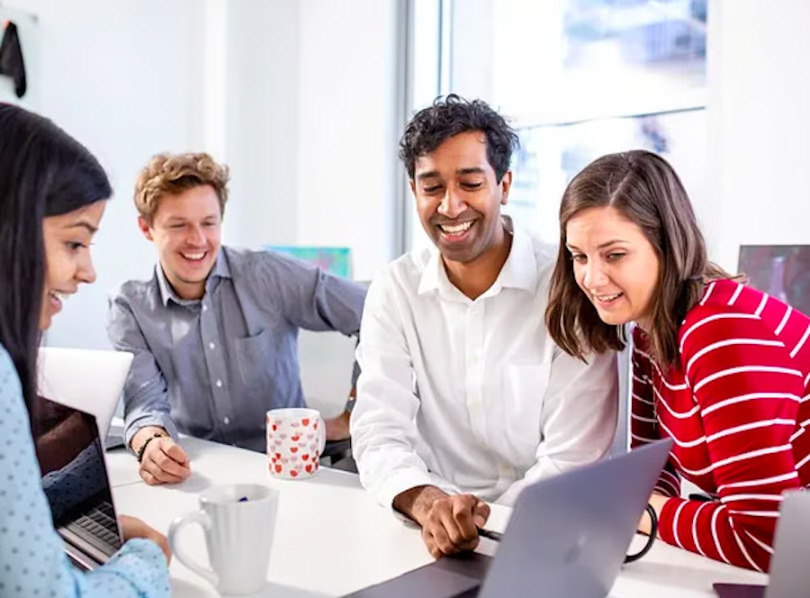 A group of Fusion employees work on a project.