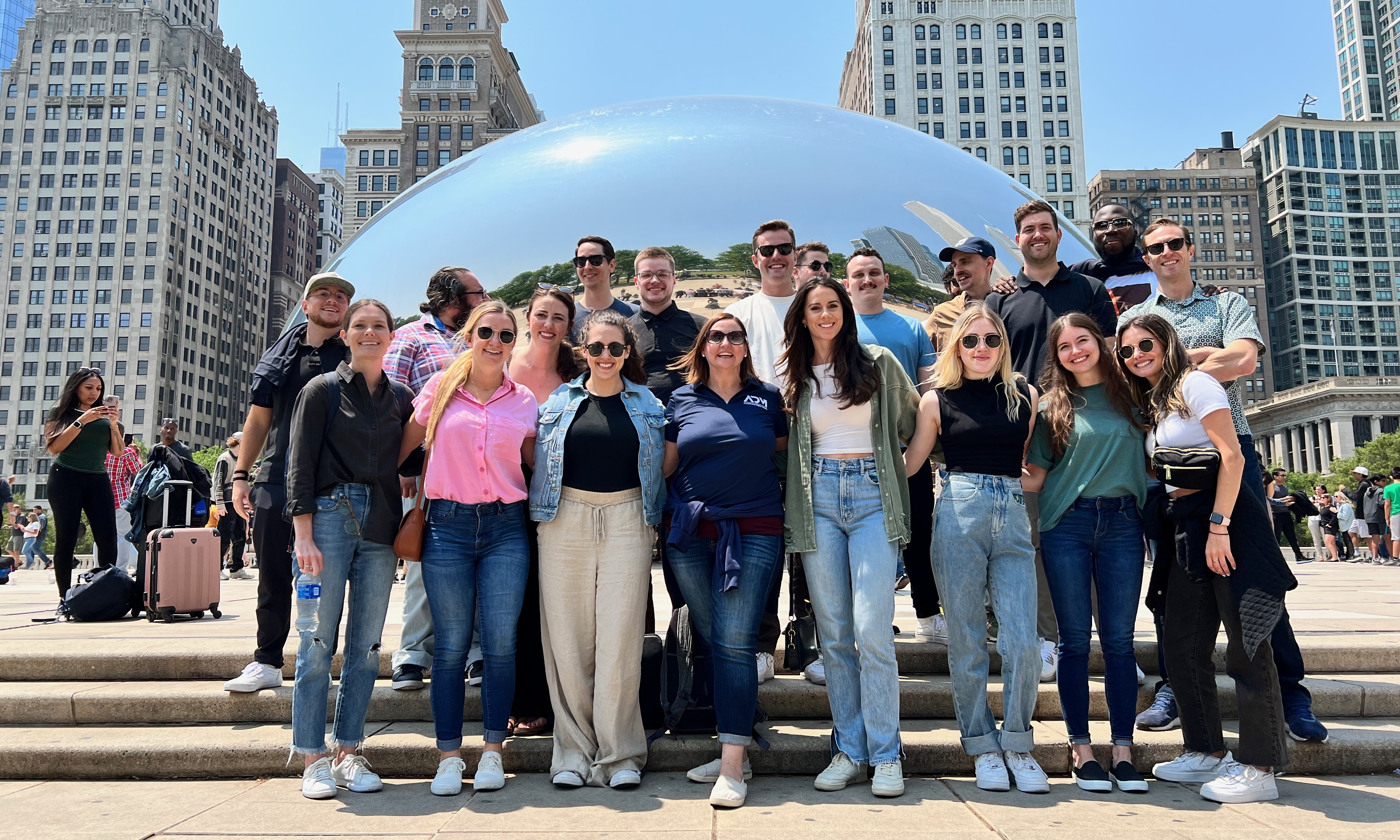 Group photo of ADM team members in front of Chicago’s Cloudgate sculpture, a.k.a. “The Bean.”