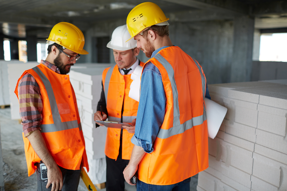 IngeniousIO — construction workers gathering around tablet
