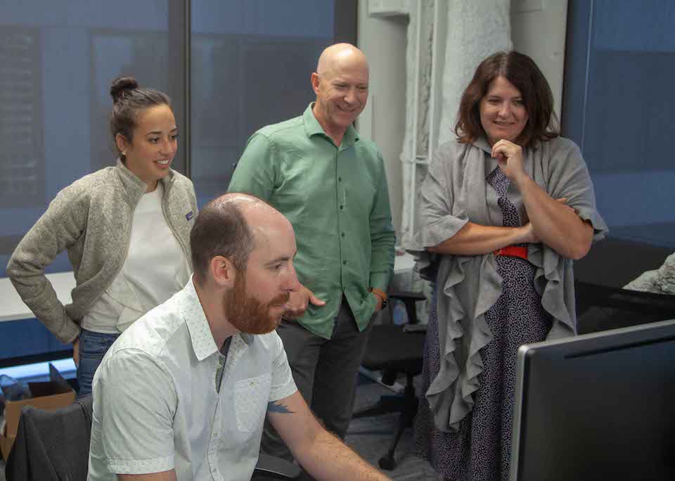 Journera staff looking at a computer