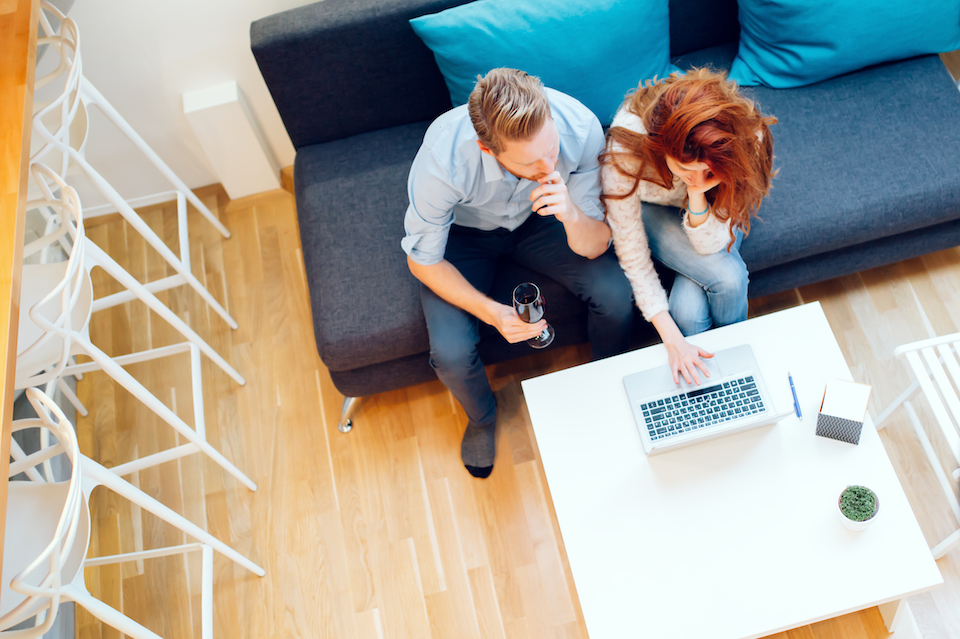 Couple in an apartment using laptop