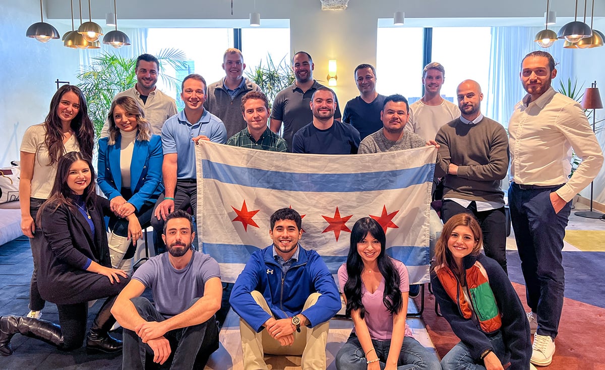 Logiwa team in the office holding up the Chicago flag