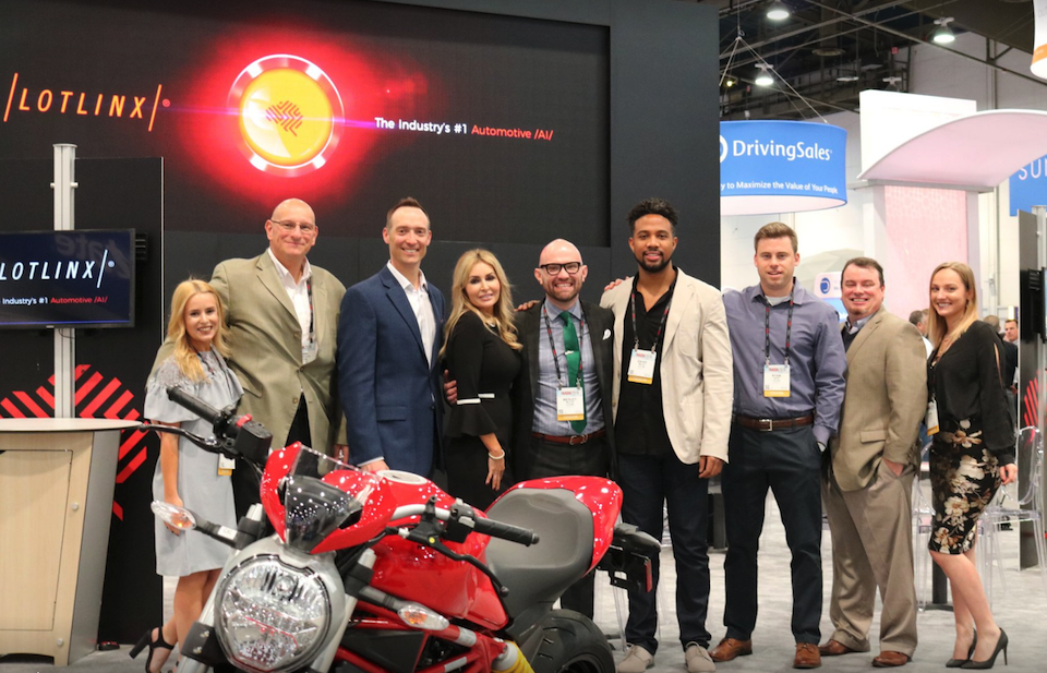 LotLinx team at conference in front of motorcycle