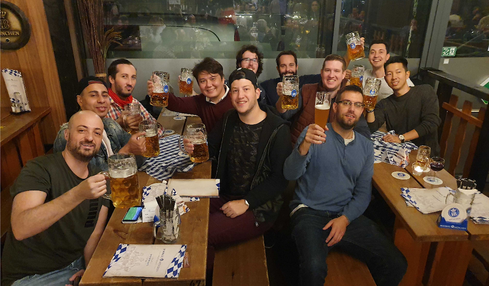 Machinio team in group photo drinking beer