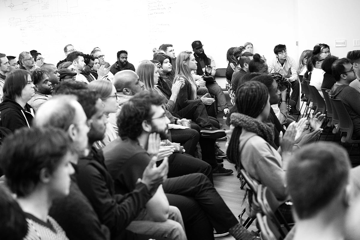 Black and white photo of OppFi team members at an all hands meeting