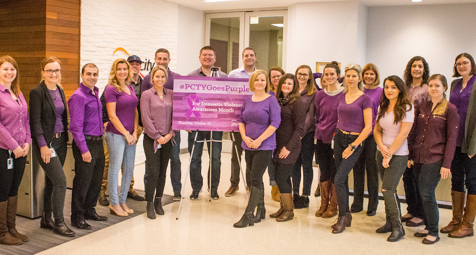 Paylocity staff purple shirts taking team photo