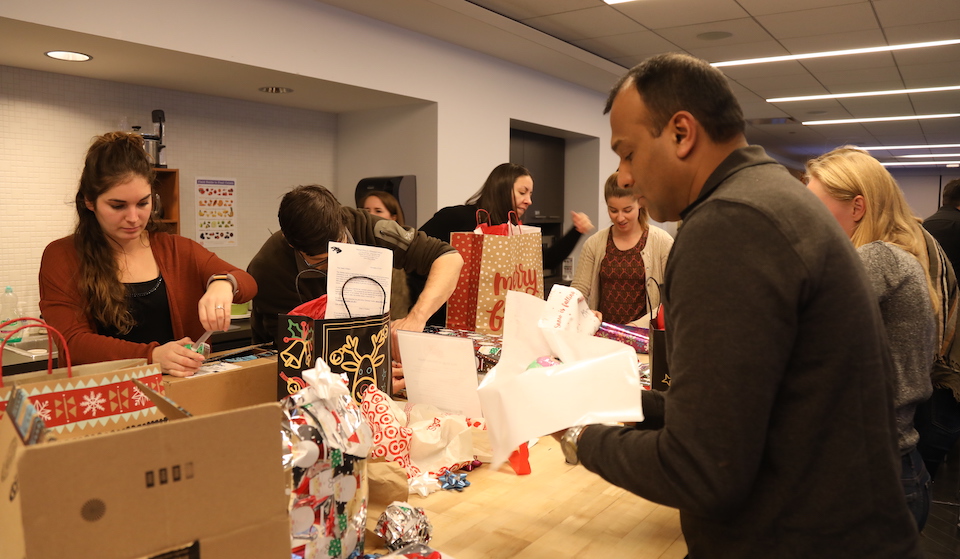 Relativity staff wrapping gifts