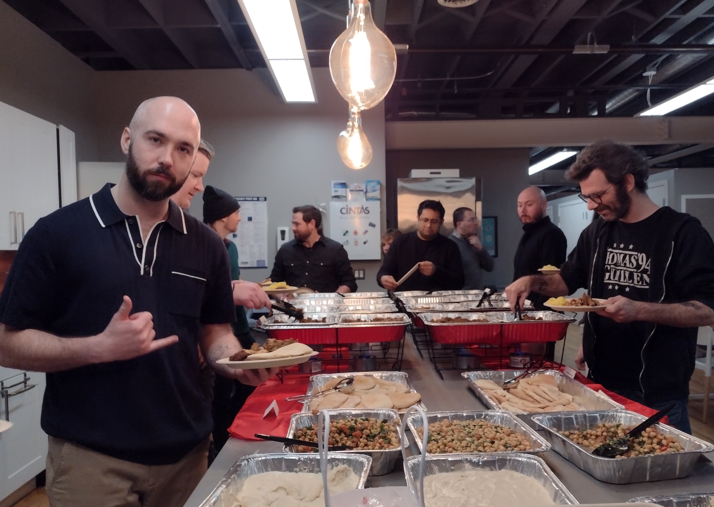 Reverb colleagues getting food from a buffet setup in the office kitchen