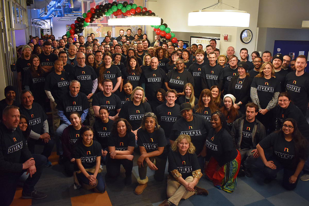 Rewards Network group photo with team members wearing matching t-shirts