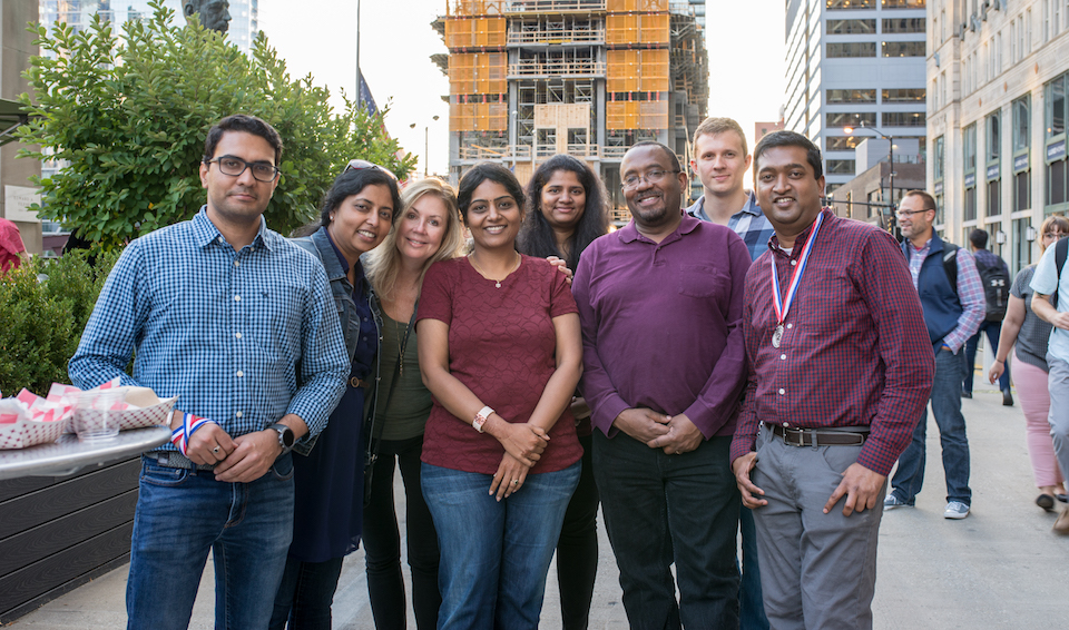 SPINS LLC team posing outdoors on the street