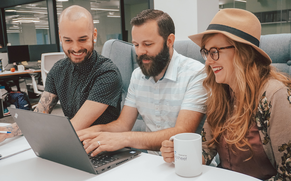 Snapsheet staff laughing at computer screen