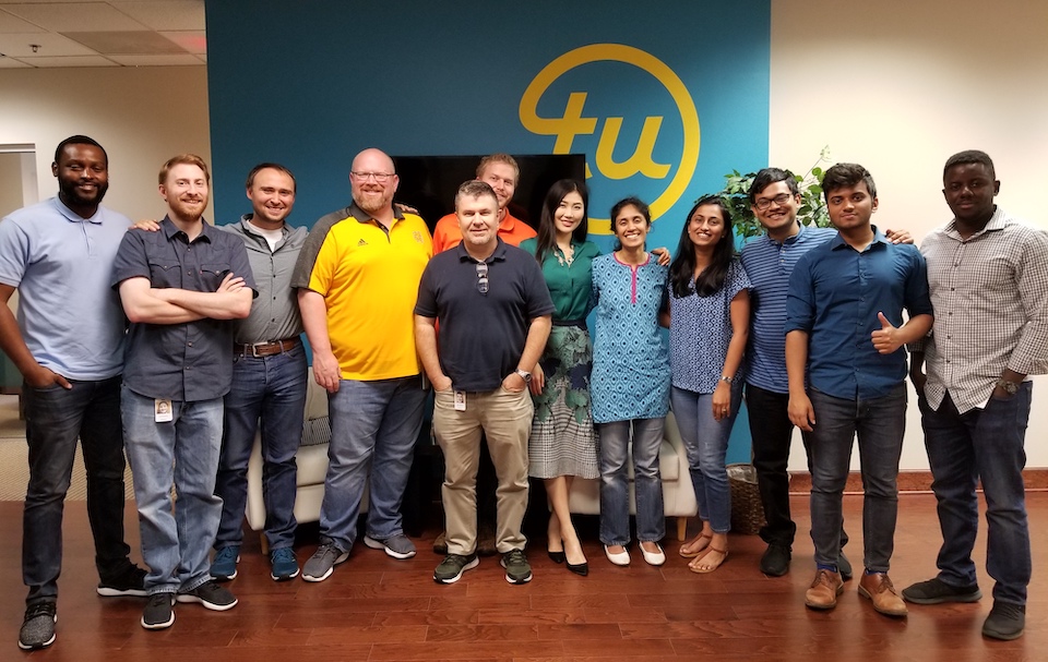 TransUnion team standing in office for photo