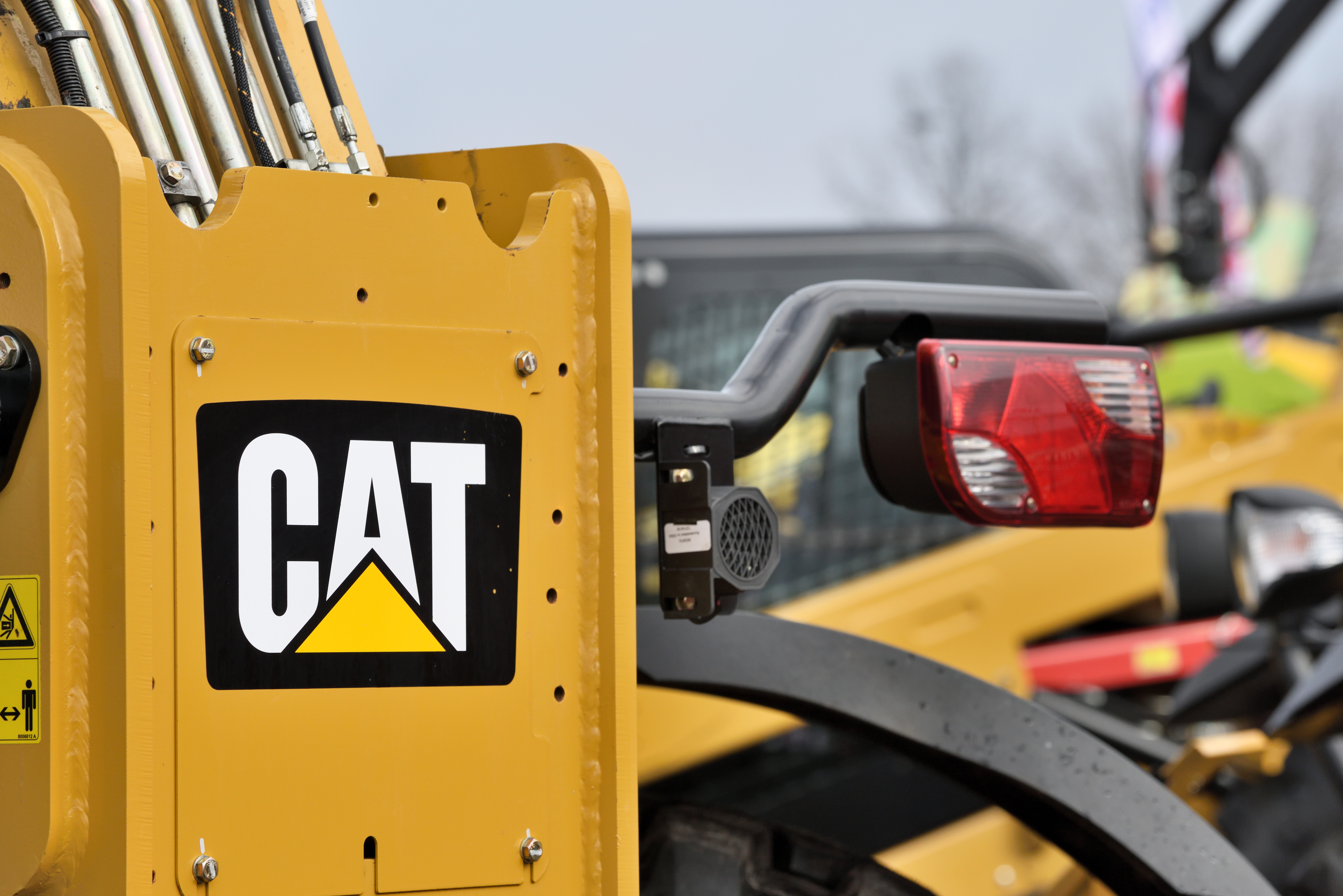 A portion of a piece of construction equipment bearing the Caterpillar logo