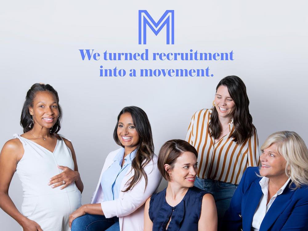 the mom project employees with company logo and slogan