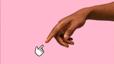 A photorealistic hand reaching out and touching pointer fingers with a hand-cursor icon against a pink background. 
