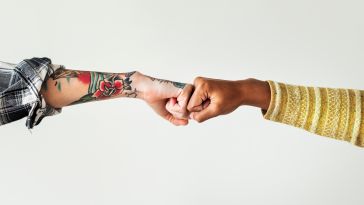 Two people fist bump. 