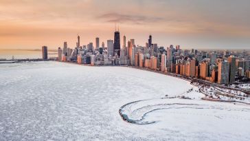 The Chicago skyline sits behind a snow covered lake