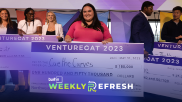 Charlotte Oxnam, the CEO and founder of Cue the Curves, stands onstage with an overside check from winning VentureCat.