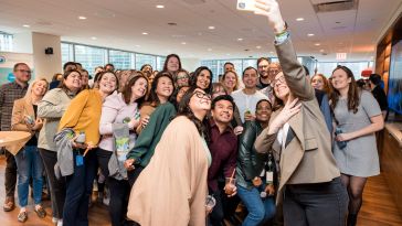 Members of the Salesforce team take a group selfie.