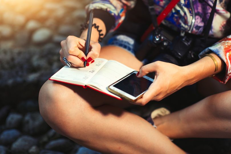 female journalist writing in notebook